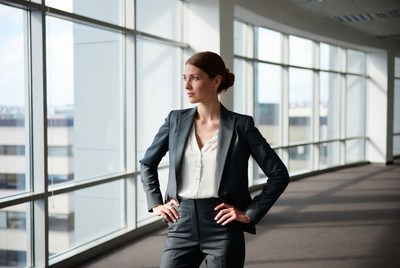 Confident woman in suit by office window
