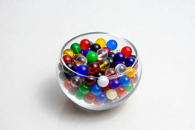 Colorful glass marbles in clear bowl