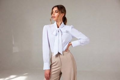 Woman in white blouse and beige pants