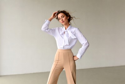 Woman in white blouse and beige pants
