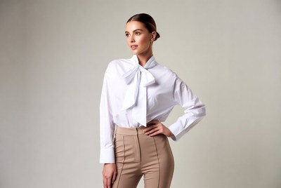Woman in white bow tie blouse and beige pants