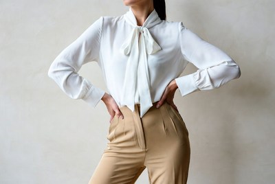 Woman in white blouse beige pants