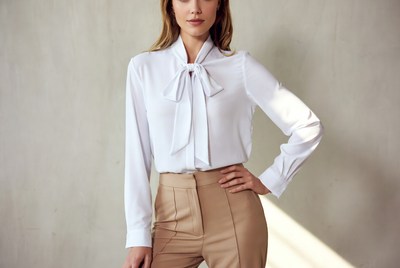 Woman in white blouse and beige pants