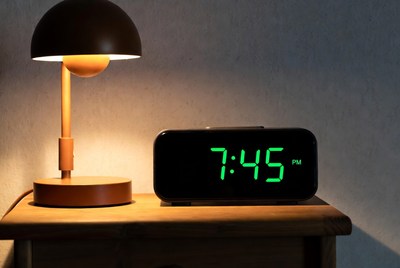 Wooden lamp and digital clock on table
