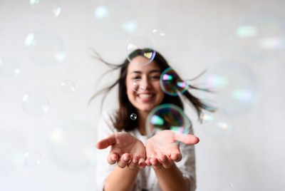 Woman holding floating bubbles