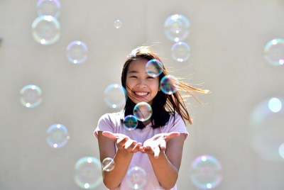 Asian girl smiling with bubbles