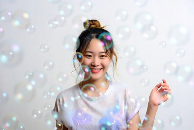 Asian woman smiling with bubbles