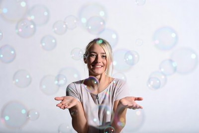 Blonde woman surrounded by bubbles