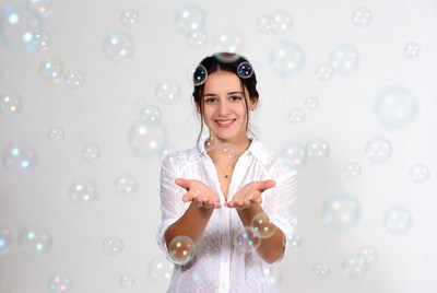 Woman holding soap bubbles