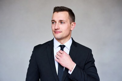 Man adjusting black tie in suit