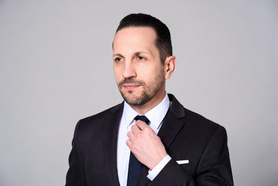 Man adjusting tie in suit