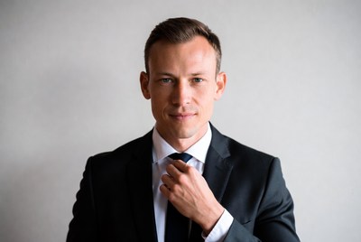 Man in suit adjusting tie
