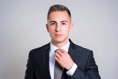 Man adjusting tie in suit