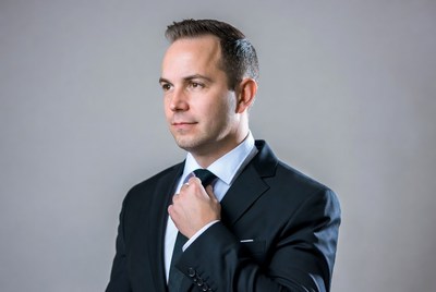 Man adjusting tie in suit