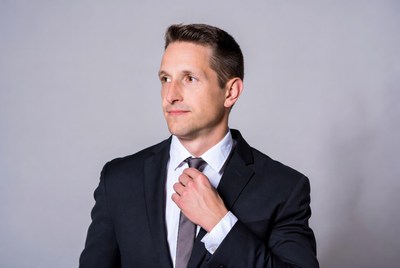 Man adjusting tie in suit