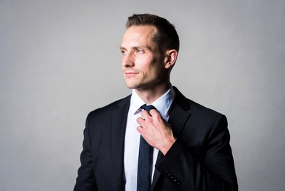 Man adjusting tie in suit