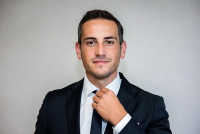 Man adjusting black tie in suit