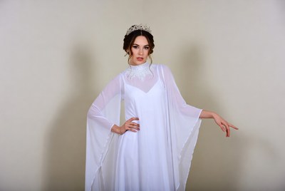 Woman in white flowing gown with tiara