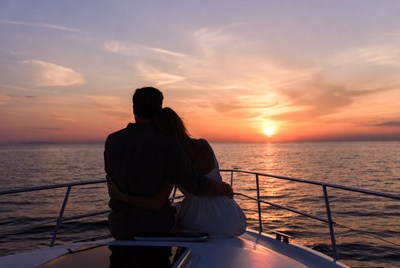 Couple embracing on yacht at sunset