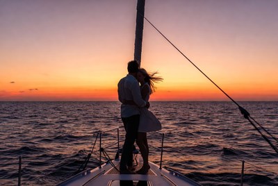 Couple embracing on yacht at sunset