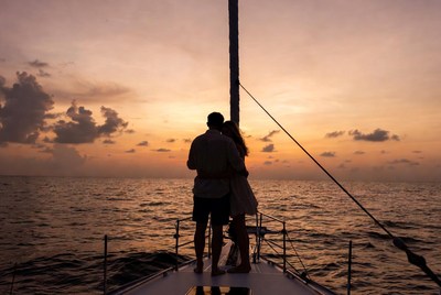 Couple embracing on yacht at sunset