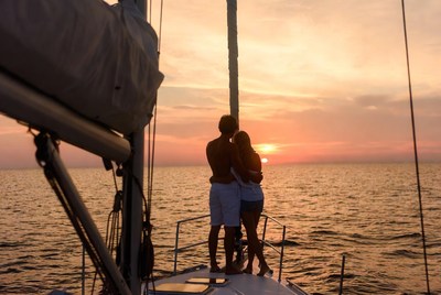 Couple embracing on yacht at sunset