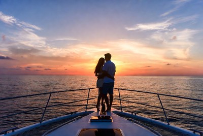 Couple embracing on yacht at sunset