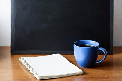 Blue Coffee Mug and Notebook on Desk