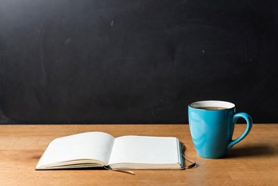 Open Notebook and Blue Coffee Mug