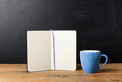 Open Notebook and Blue Mug