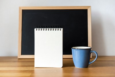 Notebook and Blue Mug by Chalkboard
