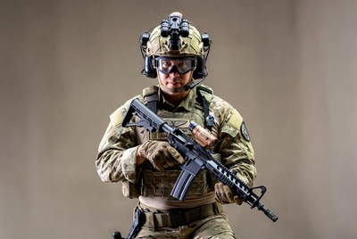 Soldier holding rifle in camouflage gear