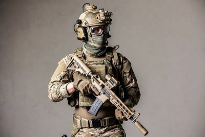 Soldier holding rifle in tactical gear