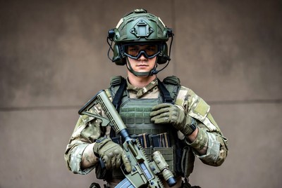 Soldier holding rifle in camouflage gear