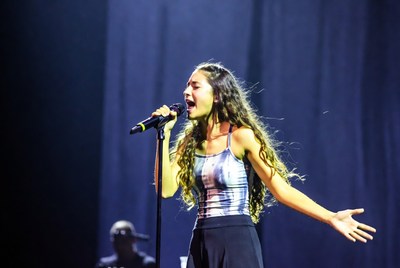 Young woman singing on stage