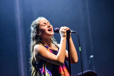 Girl singing passionately on stage
