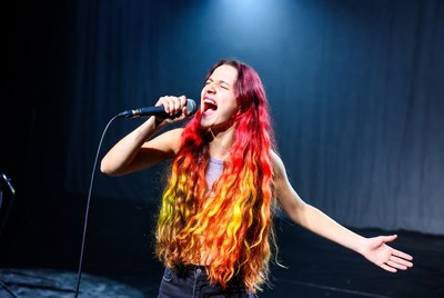 Woman singing with microphone on stage