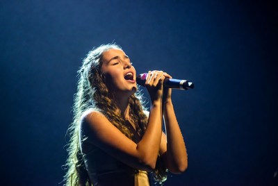 Young woman singing with microphone