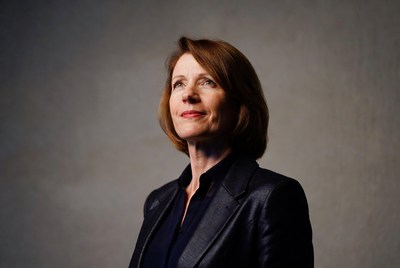 Woman in black leather jacket looking up