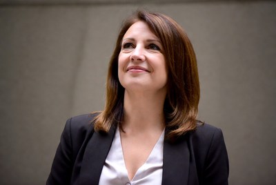 Woman in suit smiling thoughtfully