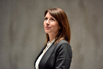 Woman in black blazer looking up