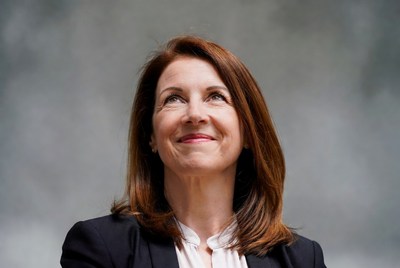 Smiling woman with red hair in suit