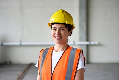 Woman wearing yellow hard hat and vest