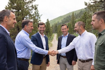 Six men shaking hands outdoors