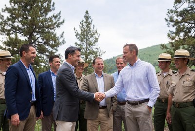 Men shaking hands with rangers outdoors
