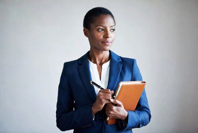 African-American woman holding notebook and pen