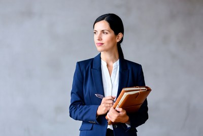Businesswoman holding notebook and pen