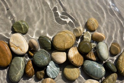 Colorful pebbles in shallow water