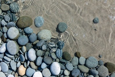 Colorful pebbles in shallow water