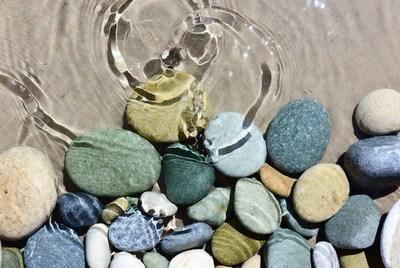 Colorful pebbles under shallow water